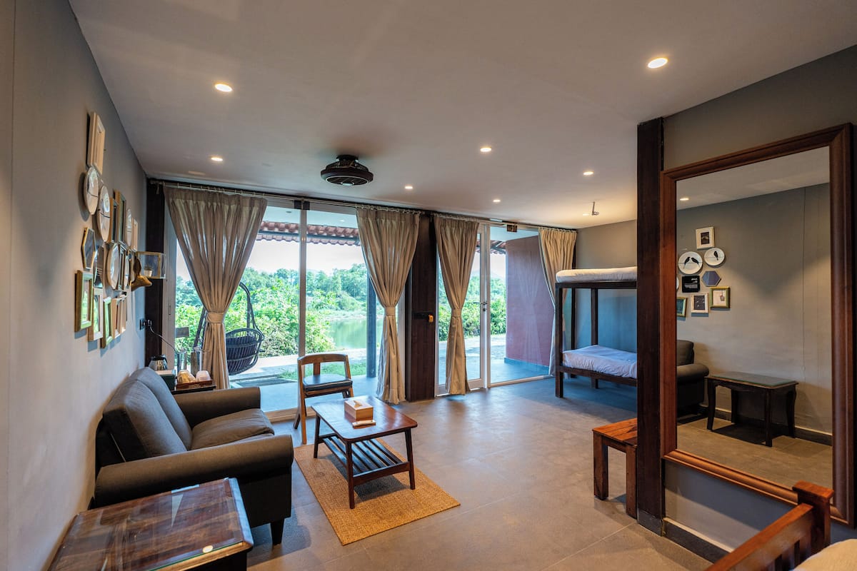 A spacious living area with a sofa, coffee table, and a view of a balcony.