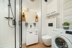 Shower, hair dryer, towels, shampoo