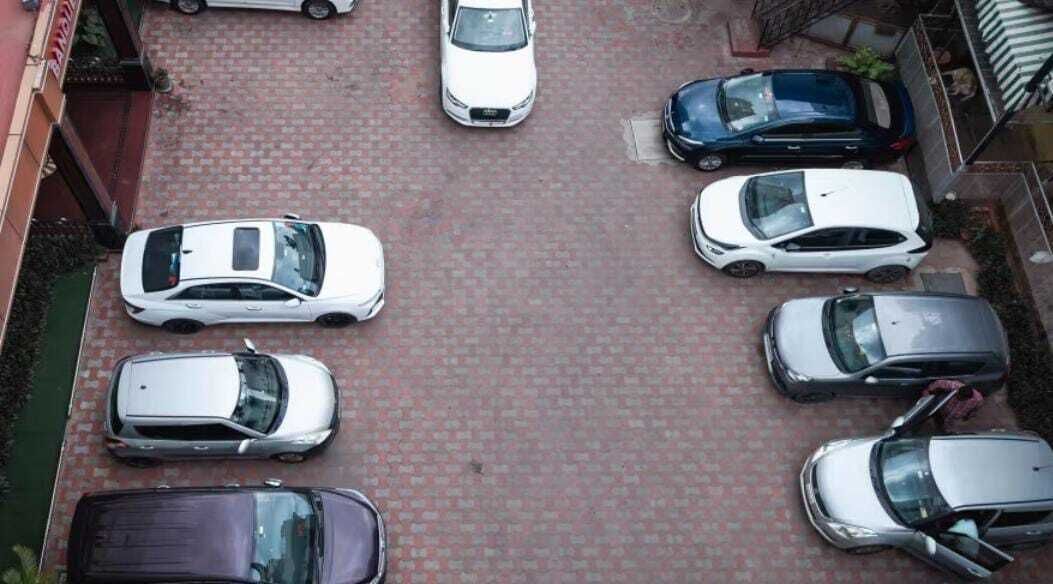 A parking lot with multiple cars parked in an orderly fashion.