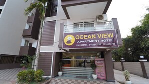 The exterior of the Ocean View Apartment Hotel with a checkered floor pattern, a balcony, and potted plants. - Ocean View The Apartment Hotel (Consua)