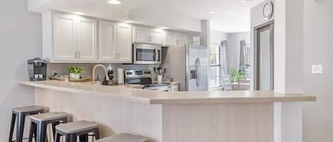 Additional bar stool seating around the kitchen area