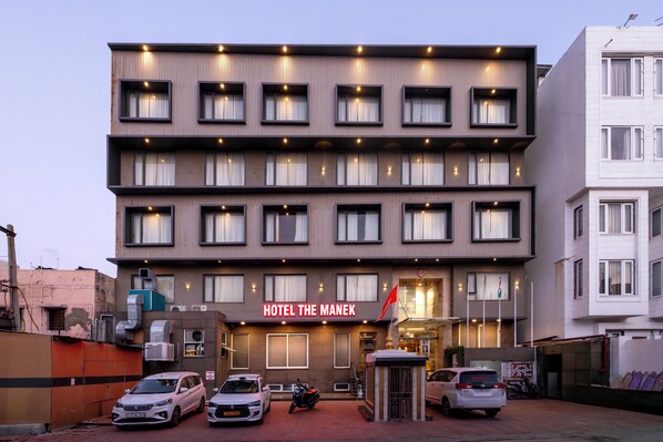 A multi-story hotel with a modern facade, multiple windows, and a prominent entrance. - Manek the Ocean View (Dwarka)