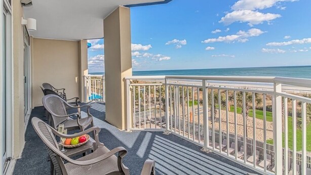 A balcony with outdoor furniture and a view of the beach. - 🌞Ocean View | Indoor Heated Water Park + Lazy River | Dunes Village Resort 338 (Myrtle Beach)