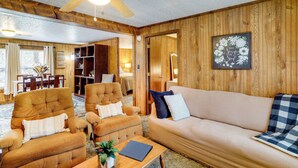 A cozy room with a wooden ceiling, a ceiling fan, a sofa, two armchairs, a coffee table with a plant, and a framed picture on the wall. - Heber Springs Cabin w/ Deck: 3 Mi to Sugarloaf Mtn (Heber Springs)