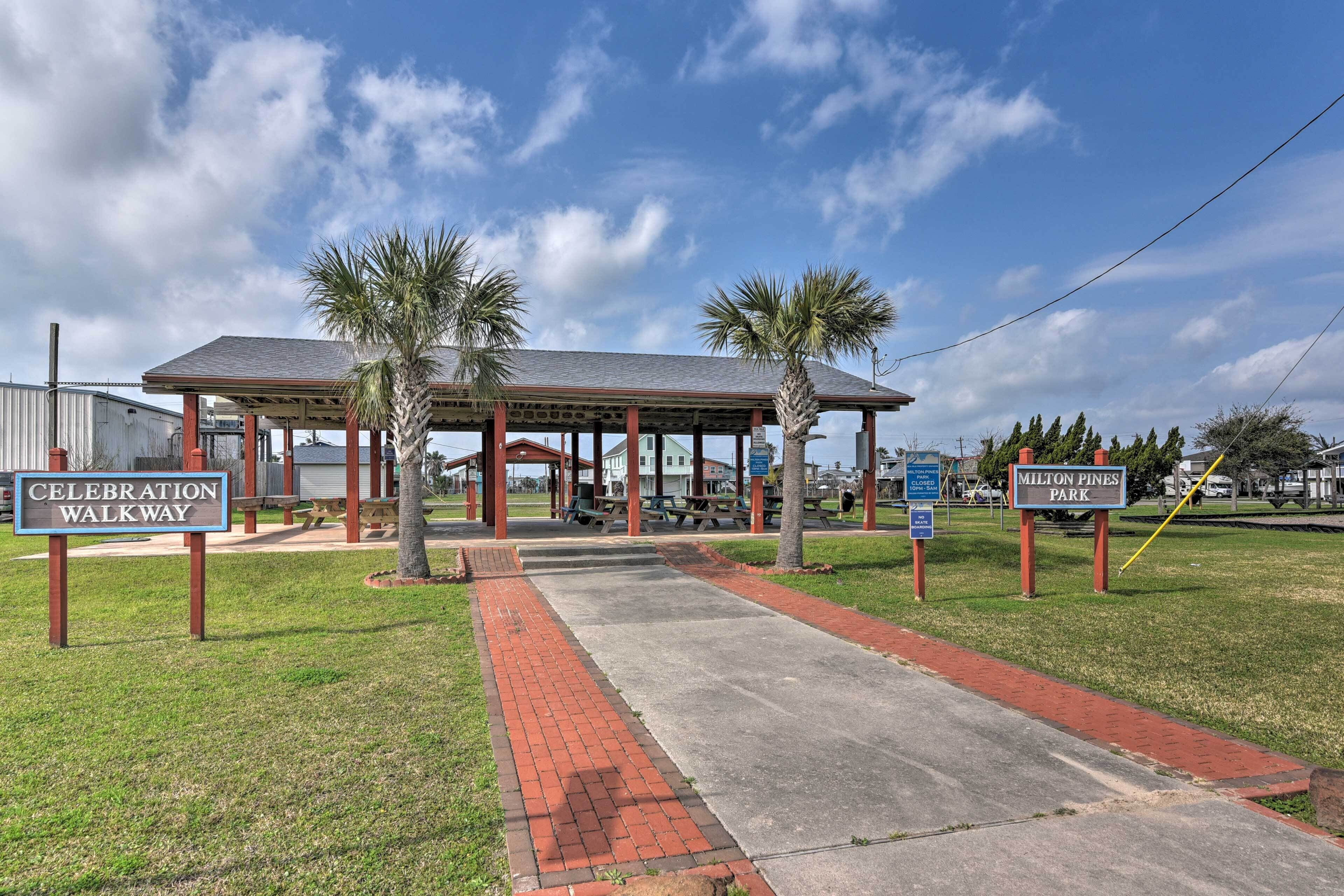 A covered pavilion with picnic tables, a Celebration Walkway sign, and a Milton Pines Park sign.