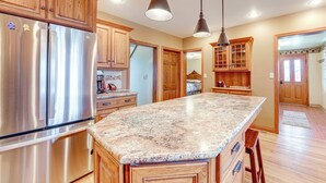 A kitchen with wooden cabinets, stainless steel appliances, and granite countertops. - Charming Tonica Farmhouse w/ Private Yard! (Tonica)