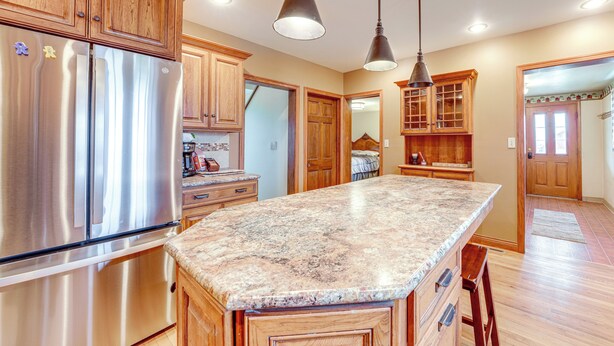 A kitchen with wooden cabinets, stainless steel appliances, and granite countertops. - Charming Tonica Farmhouse w/ Private Yard! (Tonica)