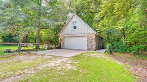A single-story house with a stone foundation and a white garage door. - 3 Mi to Silver Springs State Park: Cozy Getaway! (Silver Springs)