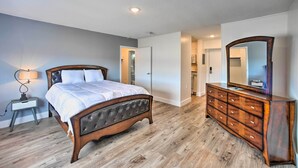 A bedroom with a bed, dresser, and a mirror. - Ideally Located Studio w/ Off-street Parking! (Gadsden)