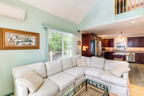 Relax in this stylish living space with a comfortable L-shaped sofa and a glass coffee table.