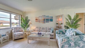 A living room with a sofa, armchairs, a coffee table, and a bookshelf. - Venice Home w/ Fenced Yard: 4 Mi to Beach! (Venice)