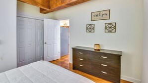 A bedroom with a bed, a dresser, and a door leading to another room. - 3 Mi to Warren Dunes: Sawyer Getaway w/ Fireplace! (Sawyer)