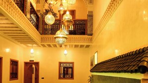 An indoor swimming pool with a green-lit water feature, ornate ceilings, and a balcony with intricate railings. - Riad Palais MERYEM (Marrakech)