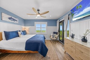 A bedroom with a bed, a ceiling fan, a window with blinds, a chair, and a dresser. - Tarpon Beach 302 3 Bedroom Condo (Sanibel)