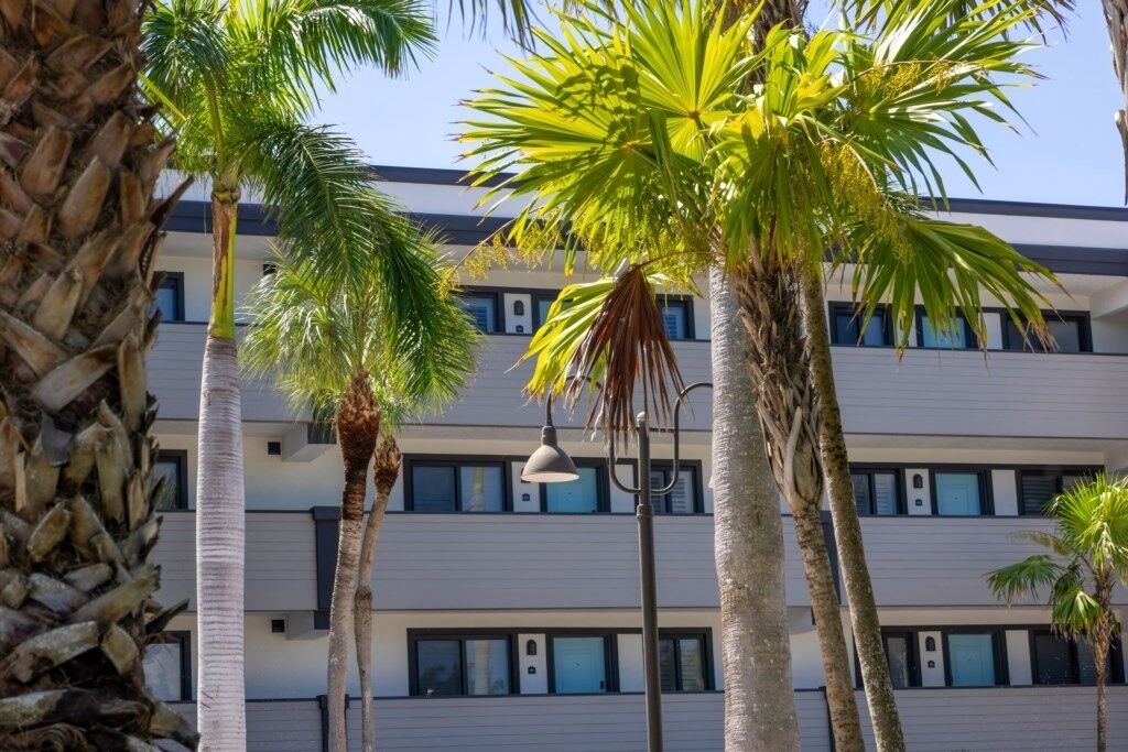 A multi-story building with a modern design, featuring a series of balconies and windows.