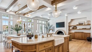 A spacious kitchen with a large island, wooden cabinets, and pendant lighting. - Rosemary 7 Bedroom Home (St. George)
