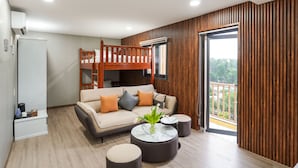 A modern living room with a bunk bed, a sofa, and a coffee table. - NV Sport Camp & Hotel - Ho Tram (Ho Chi Minh City)