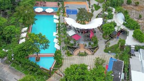 An aerial view of a resort with a swimming pool, outdoor seating areas, and a landscaped garden. - NV Sport Camp & Hotel - Ho Tram (Ho Chi Minh City)