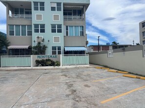 A multi-story building with a sign reading "MONTEMAR" and a gated entrance.