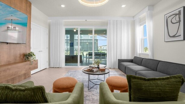 Un salon moderne avec un canapé gris, des fauteuils verts et une table basse ronde.