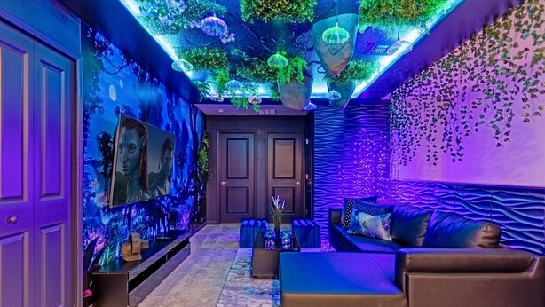 A room with a sofa, a coffee table, and a wall-mounted TV. - Last Minute Disney Getaway! Private Pool & Game Room. Book Now! #121741 (Orlando)