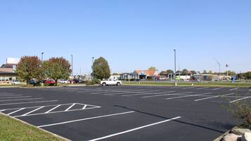 A parking lot with marked spaces and a white truck parked in the distance.