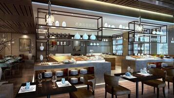A modern restaurant interior with a central island, dining tables, and hanging pendant lights.