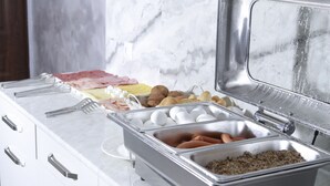 A buffet setup with various food items including eggs, sausages, and meats. - Opera Avenue Hotel Yerevan (Yerevan)