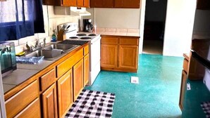 A compact kitchen with wooden cabinets, a stove, and a sink.