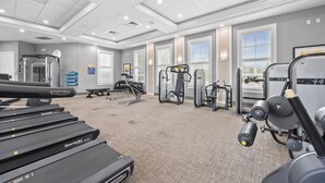 A gym with treadmills, weight machines, and exercise equipment.