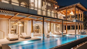A modern multi-story building with a swimming pool and outdoor seating area. - Ocaso Culturally Rich Villa, Flamingo Beach (Flamingo)