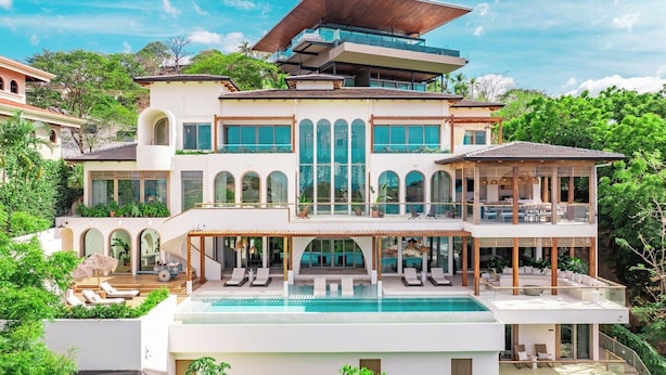 A multi-story house with a pool, outdoor seating, and a large balcony. - Ocaso Culturally Rich Villa, Flamingo Beach (Flamingo)