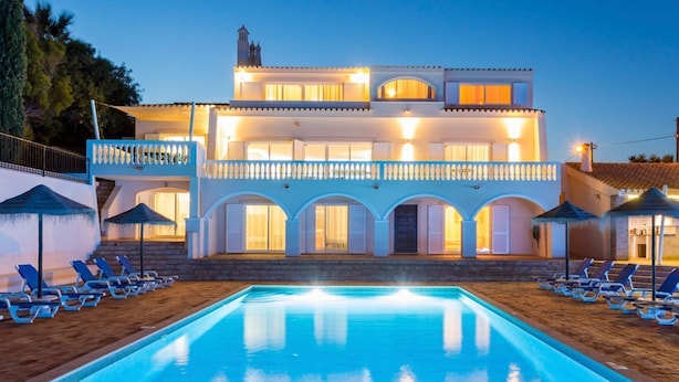 A two-story building with a swimming pool, multiple balconies, and sun loungers. - Villa Cristallo - Ten Bedroom Villa, Sleeps 20 (Praia da Luz)