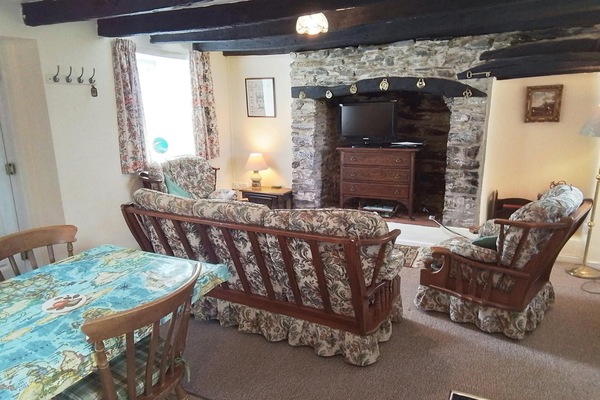 Lounge area with sofa, armchair, fireplace