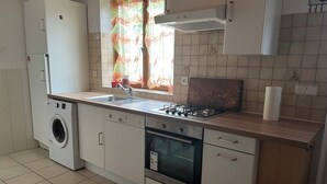 A modern kitchen with a built-in washer, dishwasher, oven, and gas stove.