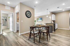 A modern kitchen with white cabinets, a built-in oven, and a microwave. - Trillium (Melbourne)