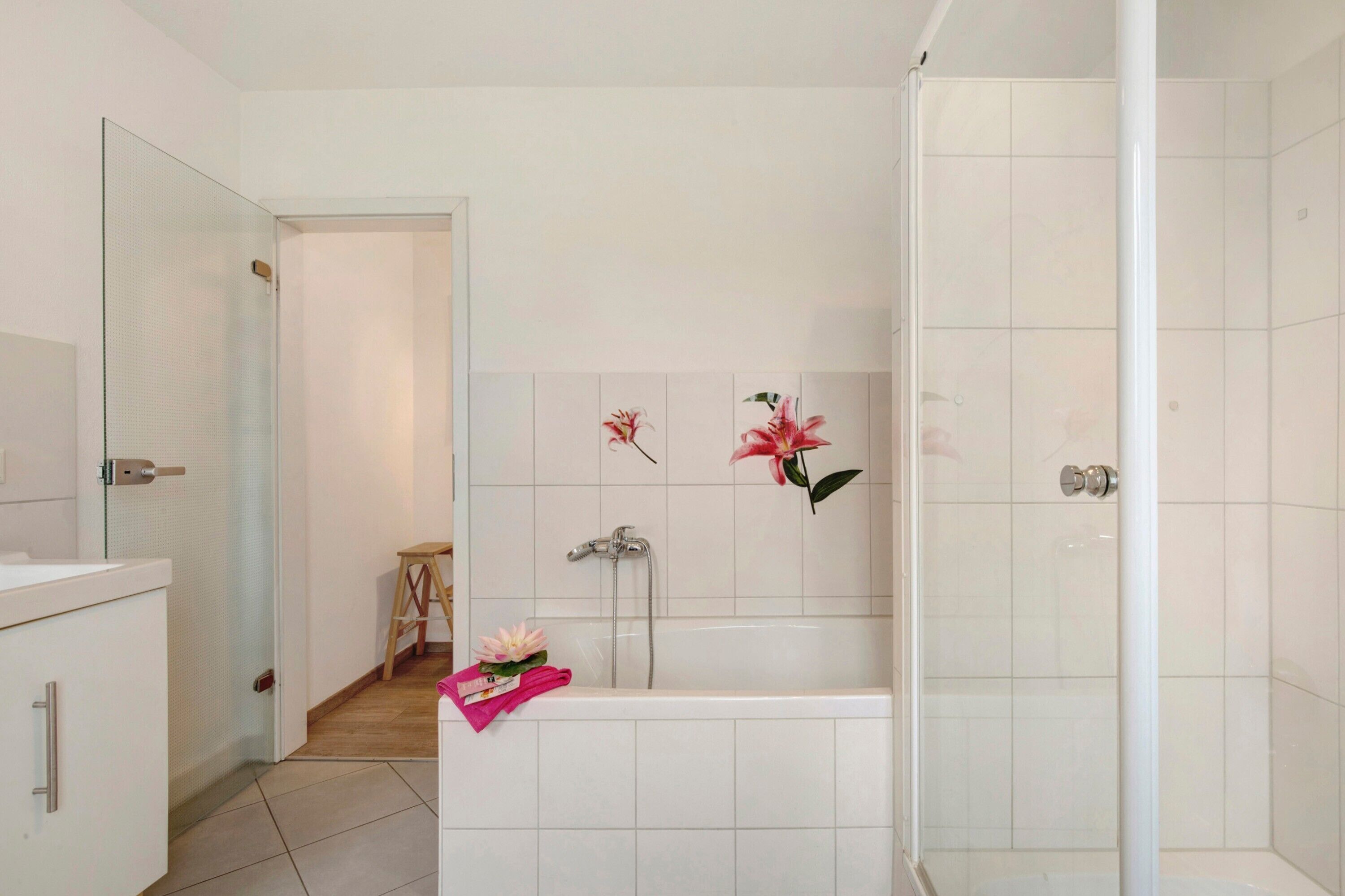 A bathroom with a shower, a toilet, and a sink.