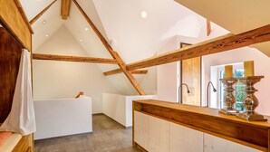 A modern interior with a wooden ceiling, a white bathtub, and a wooden counter with a candle holder. - Apartment 'Gästehaus Wüpping 3' with Mountain View, Private Terrace and Wi-Fi (Salem)