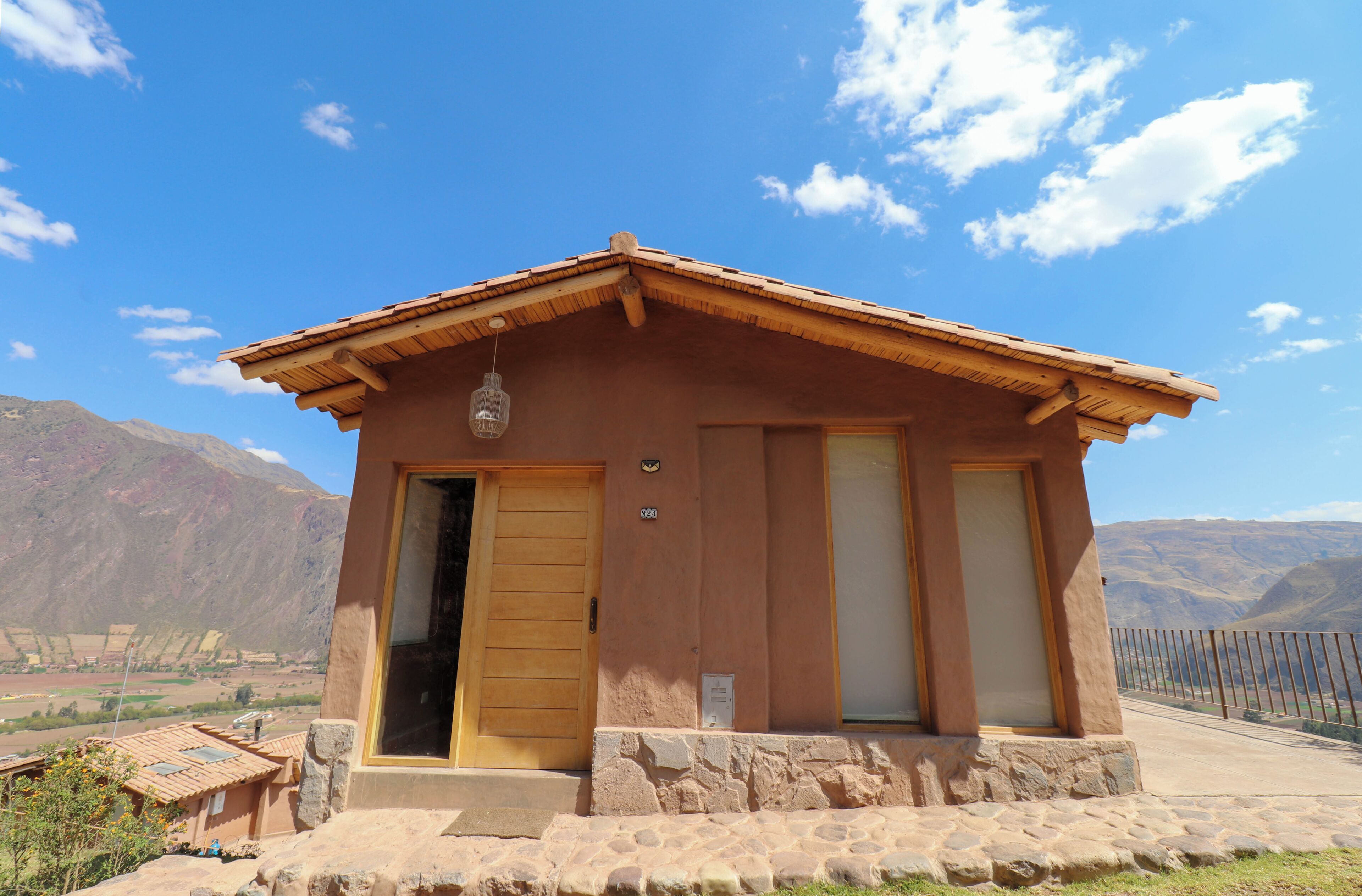 A small, single-story building with a sloped roof and a stone foundation.