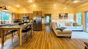 A cabin interior with a kitchen, dining area, and living room. - Beautiful Mountain View - Charming 2-bedroom house in Murphy, NC (Murphy)