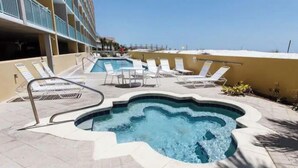 A pool area with lounge chairs and a hot tub. - 🦩Book Me Baby! Pelican Isle #604 Penthouse Paradise 🦩 (Fort Walton Beach)