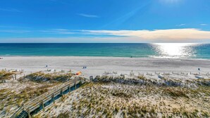 A beach with a wooden boardwalk leading to the shore, clear skies, and calm sea. - 🦩Book Me Baby! Pelican Isle #604 Penthouse Paradise 🦩 (Fort Walton Beach)