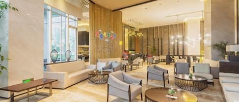 A spacious lobby with seating areas, a reception desk, and large windows.