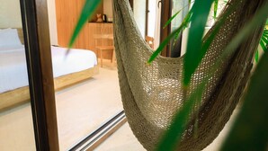 A hammock in a room with a bed and a wooden cabinet. - Room with Private Terrace and Pool |• TEVA 4B (Tulum)
