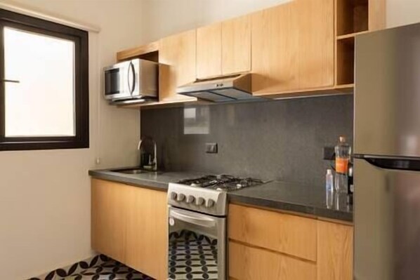Fridge, microwave, coffee/tea maker, cookware/dishes/utensils