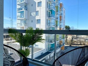 A modern apartment building with balconies, large windows, and a view of the street. - Borg Housing Travel Center (Pori)