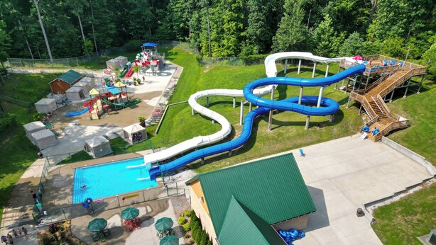 An aerial view of a water park with a large pool, multiple slides, and picnic areas. - Sun Outdoors Lake Rudolph (Santa Claus)