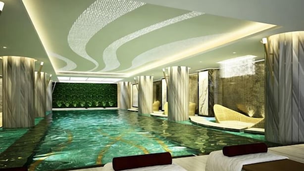 A spa room with a large indoor pool, seating areas, and a green wall. - Ascott Heng Shan Shanghai (Shanghai)