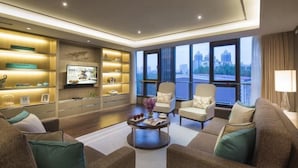 A modern living room with a sofa set, a coffee table, and a TV on a wall. - Ascott Heng Shan Shanghai (Shanghai)
