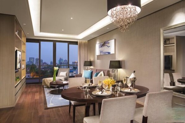 A modern hotel room with a dining area, large windows, a chandelier, and a city view. - Ascott Heng Shan Shanghai (Shanghai)
